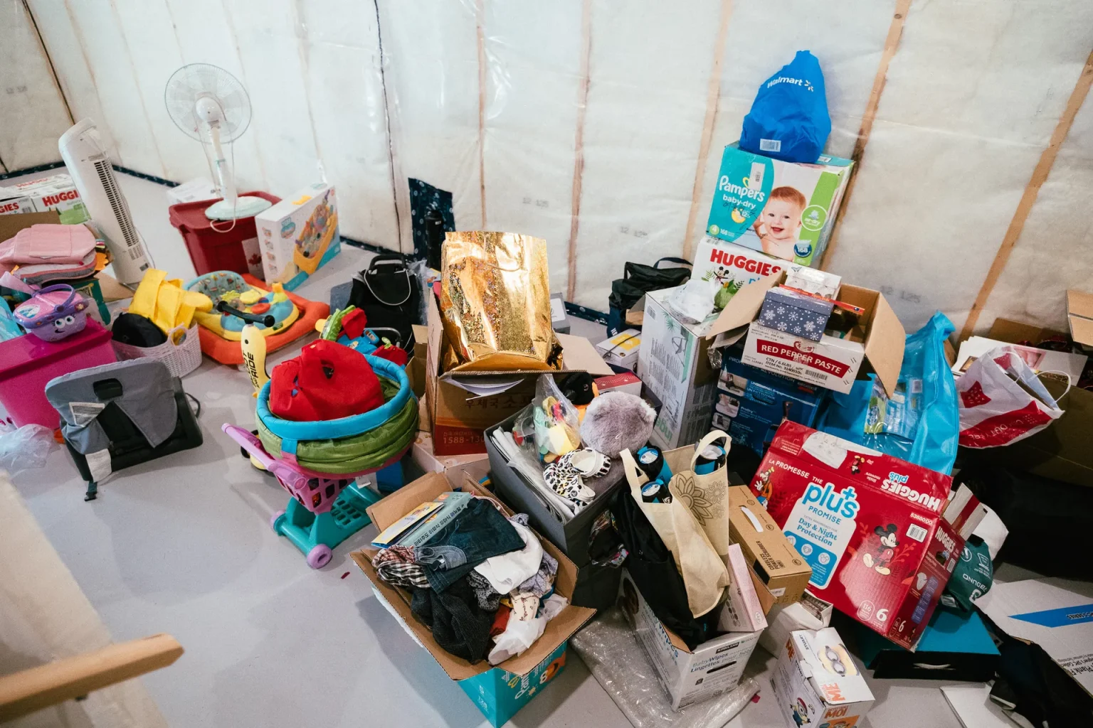 A chaotic assortment of boxes and items piles up in a cluttered space